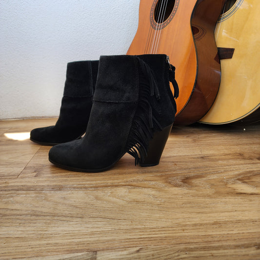 Side view of the Ash black fringe suede boots showing the fringe details down the side.