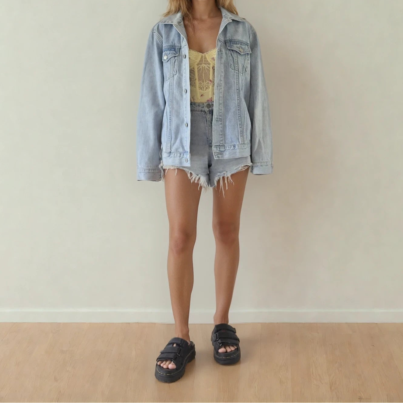 Front view of model wearing the Assembly Label denim jacket, showing the button front, light denim and front pockets