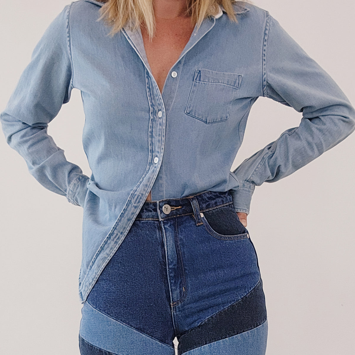Blue high rise jeans with patchwork design at the front.