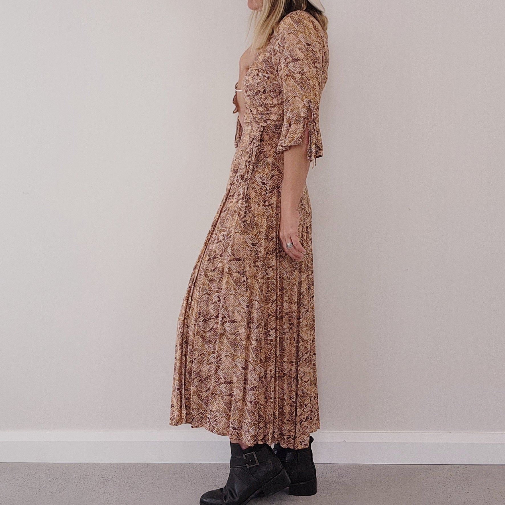 Side view of model wearing the Auguste the Label, Pia brown snake print wrap dress, showing the soft 3/4 length tie sleeves.