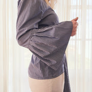 C&M wrap top with bell sleeves in a wrap style. Blue and white stripe. Available online at Wilson Avenue