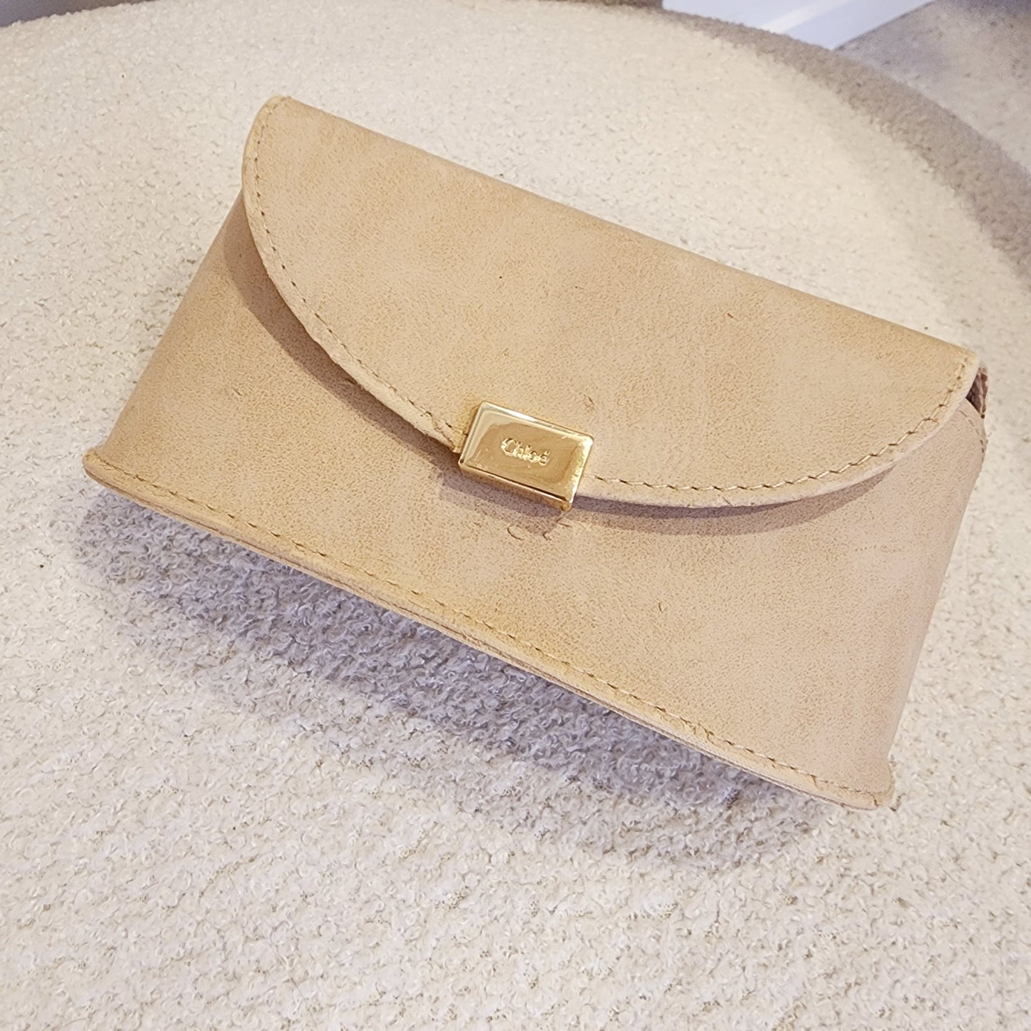 Front view of the Chloe sunglasses case showing the peeling material.