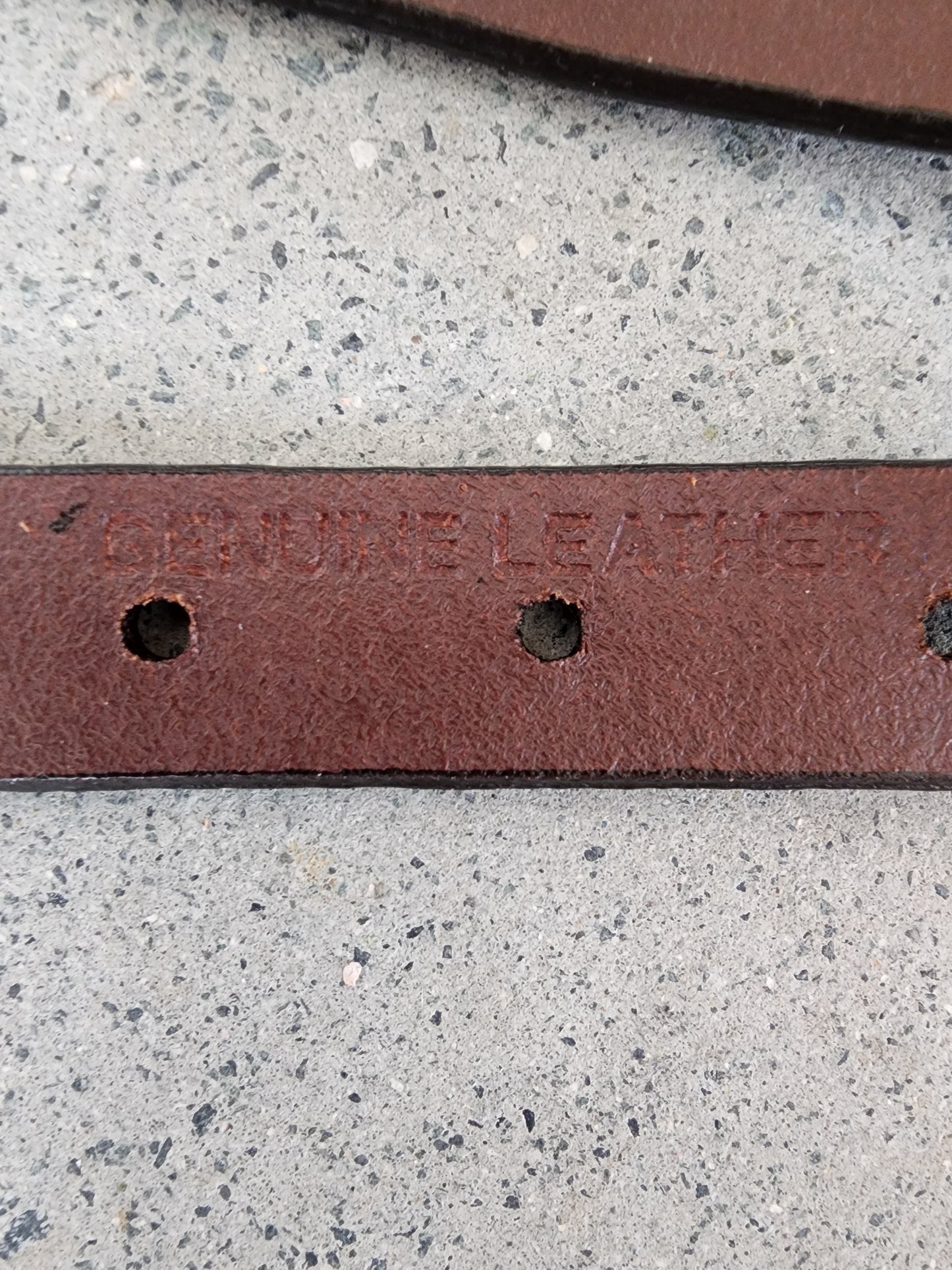 Close up of Dockers belt showing the genuine leather imprint in the leather.