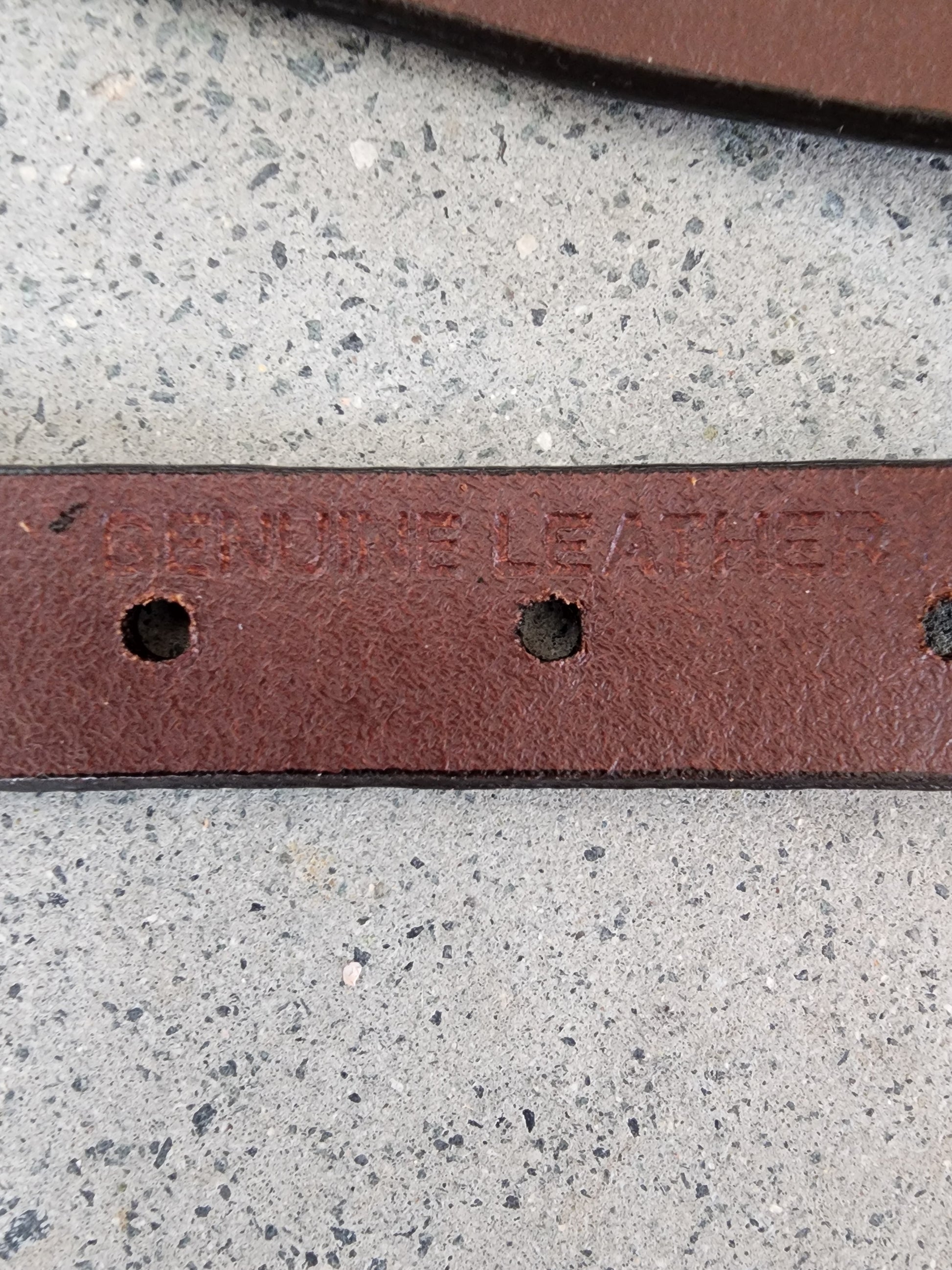 Close up of Dockers belt showing the genuine leather imprint in the leather.
