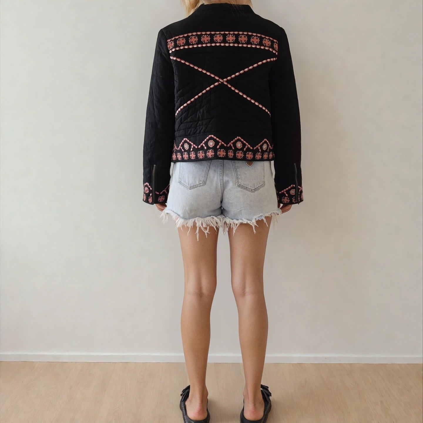 Back view of the Flannel quilted embroidered jacket, showing the cross-back design and zip-up sleeve details.