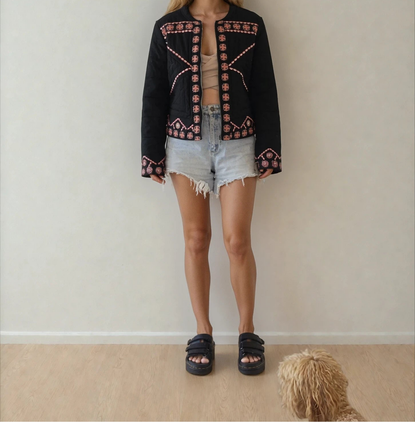 Front view of the Flannel black embroidered jacket worn with denim shorts.