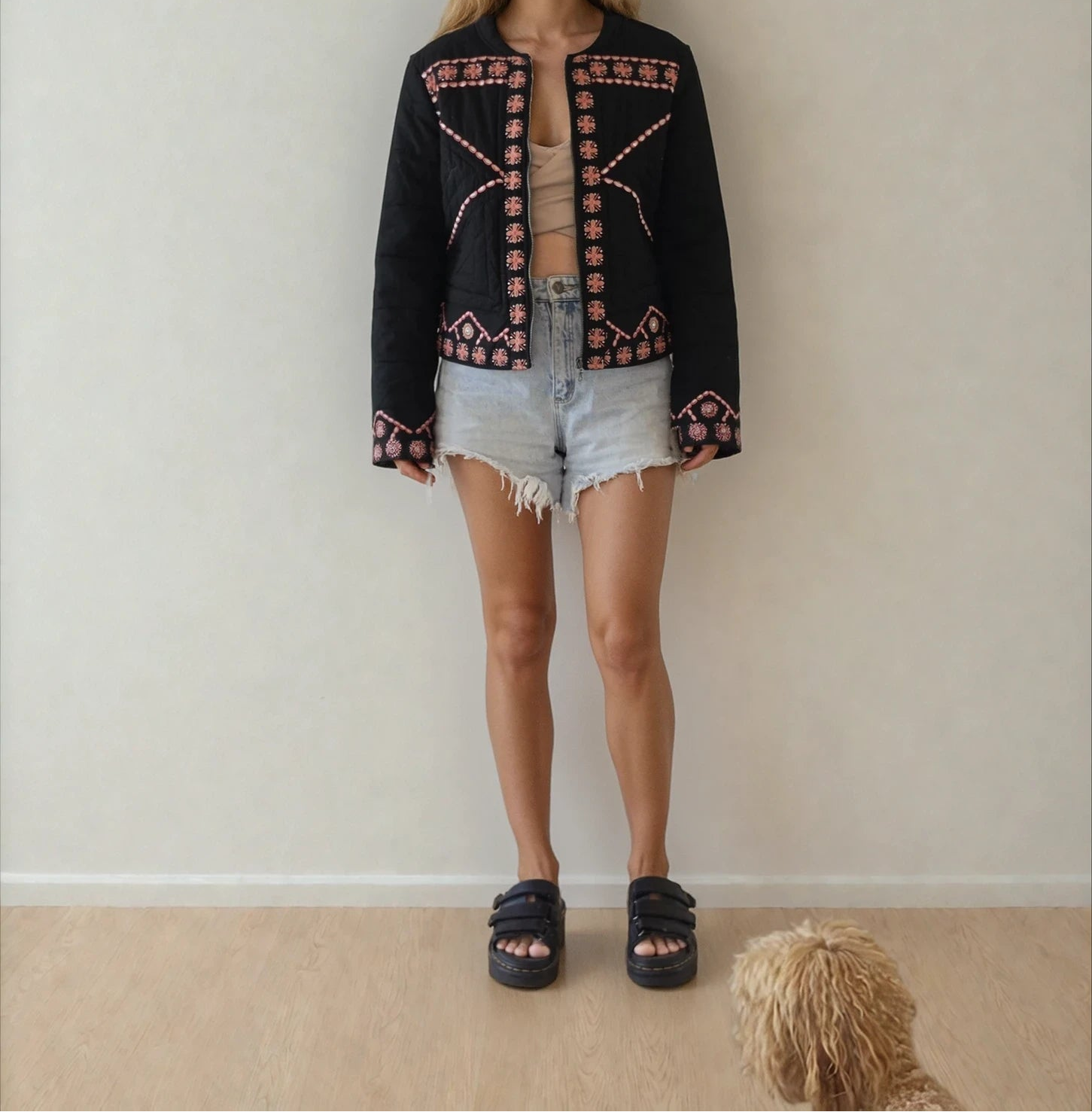 Front view of the Flannel black embroidered jacket worn with denim shorts.
