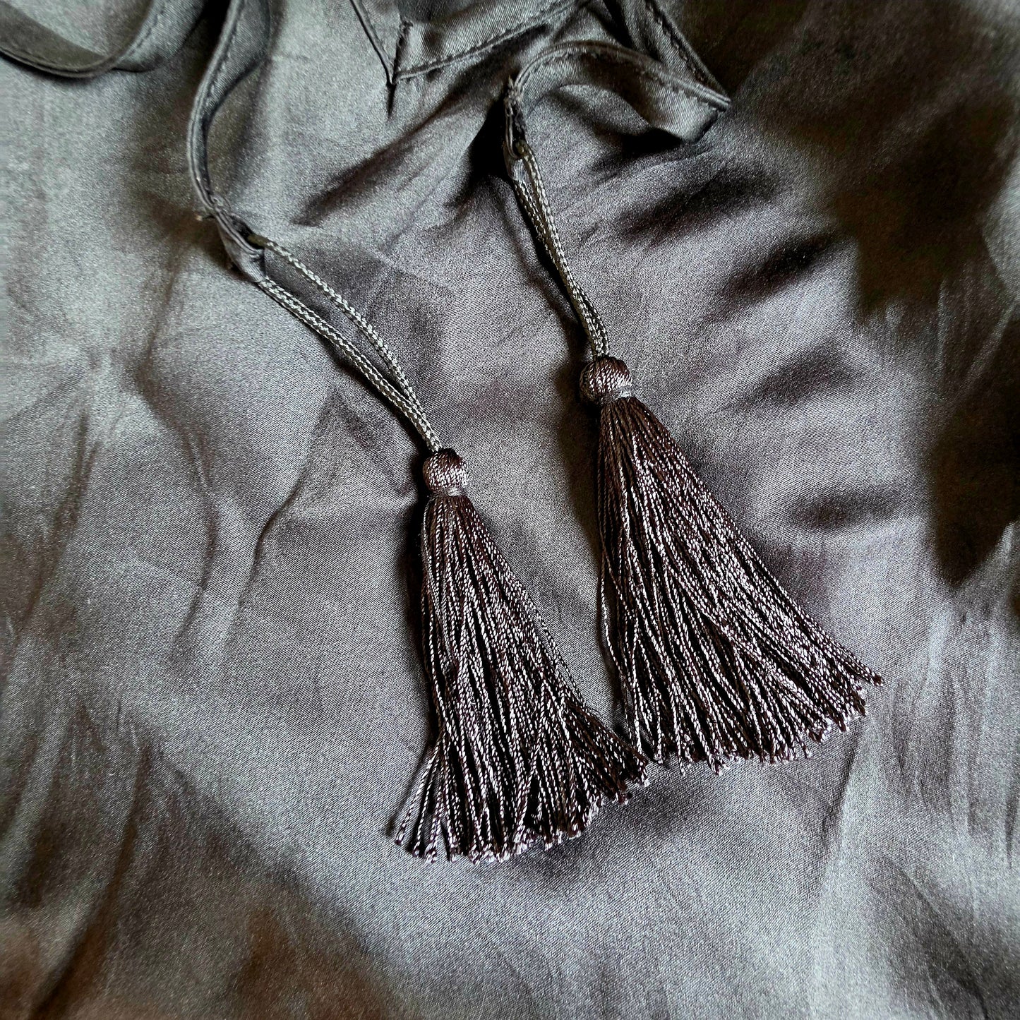 Image showing the tassels at the end of the back tie on the Gracie Jack silk slip dress.