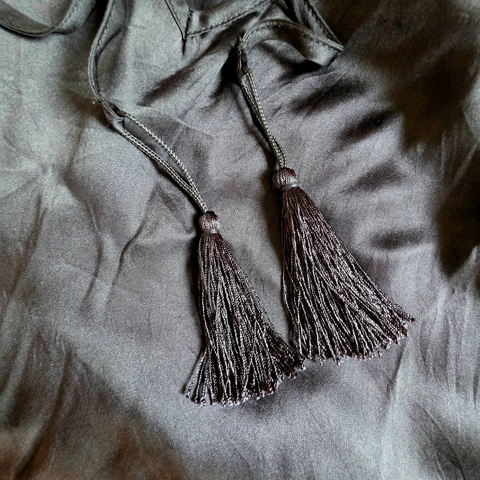 Image showing the tassels at the end of the back tie on the Gracie Jack silk slip dress.