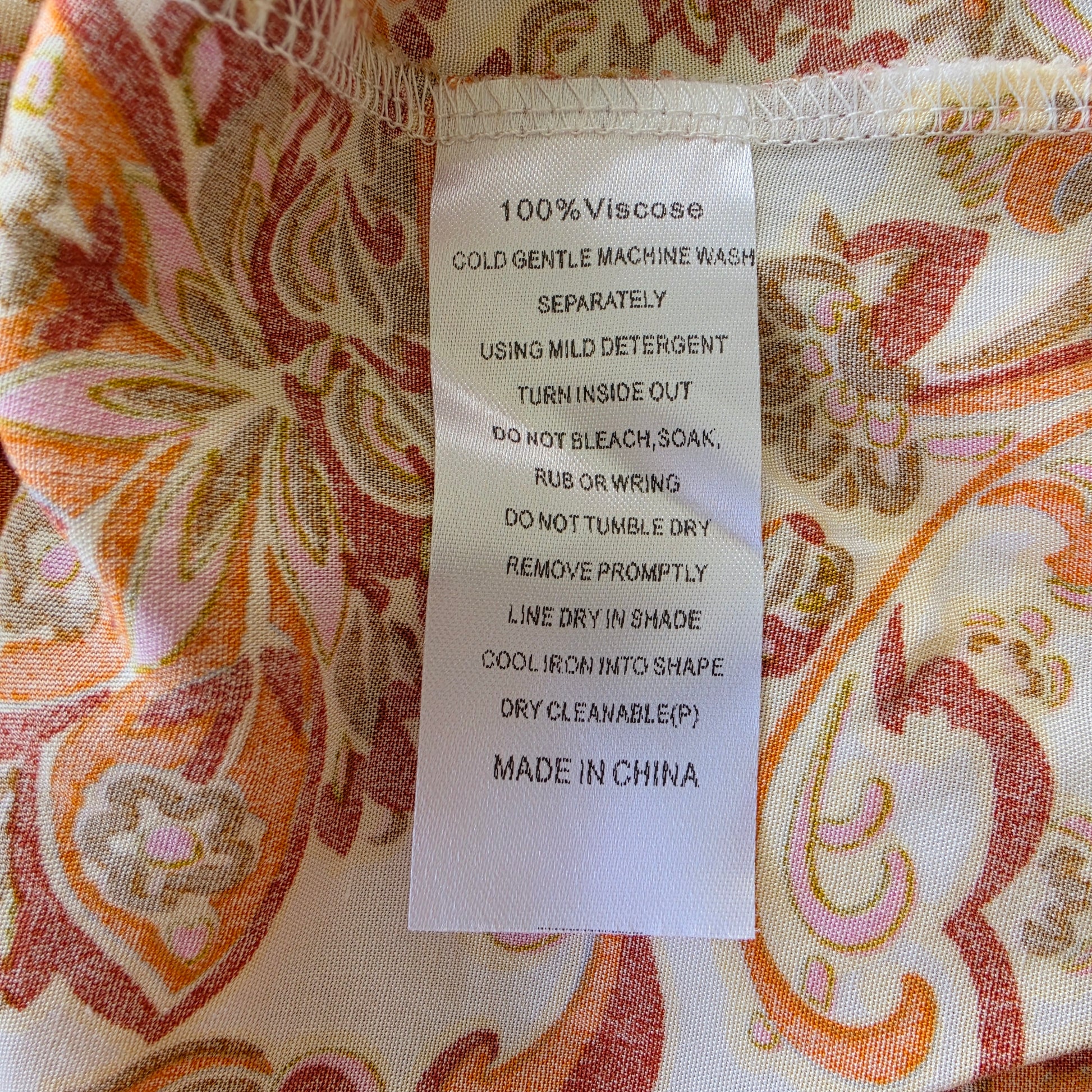 Image showing the inside label of the Gysette paisley button up, long sleeve top in size 6