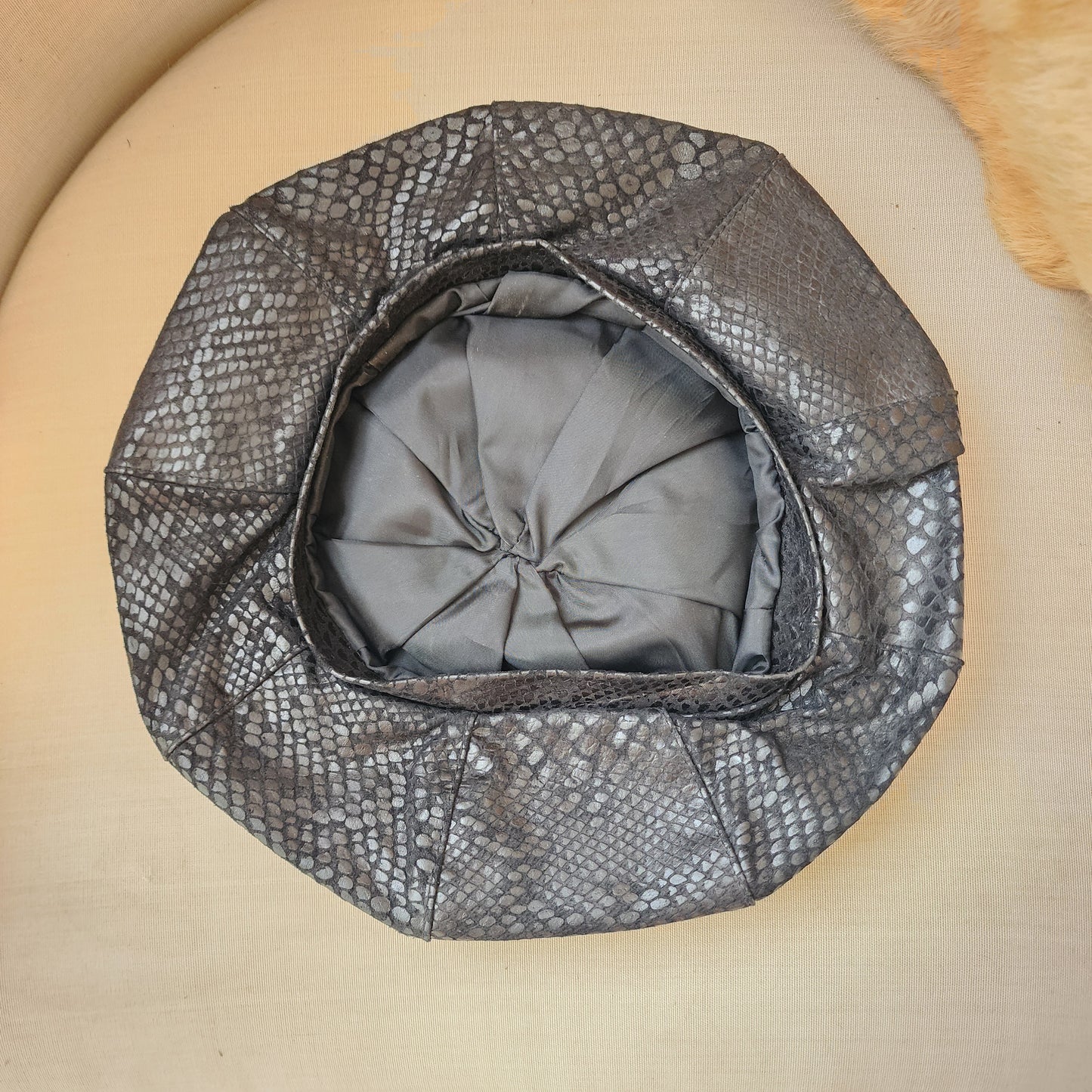 INside view of structured vintage suede beret in serpent print with taffeta lining.