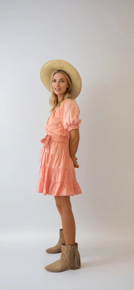 Kivari Alice tiered wrap mini dress in size 12. Salmon pink colour with a tie waist and puff sleeves. Available at Wilson Avenue