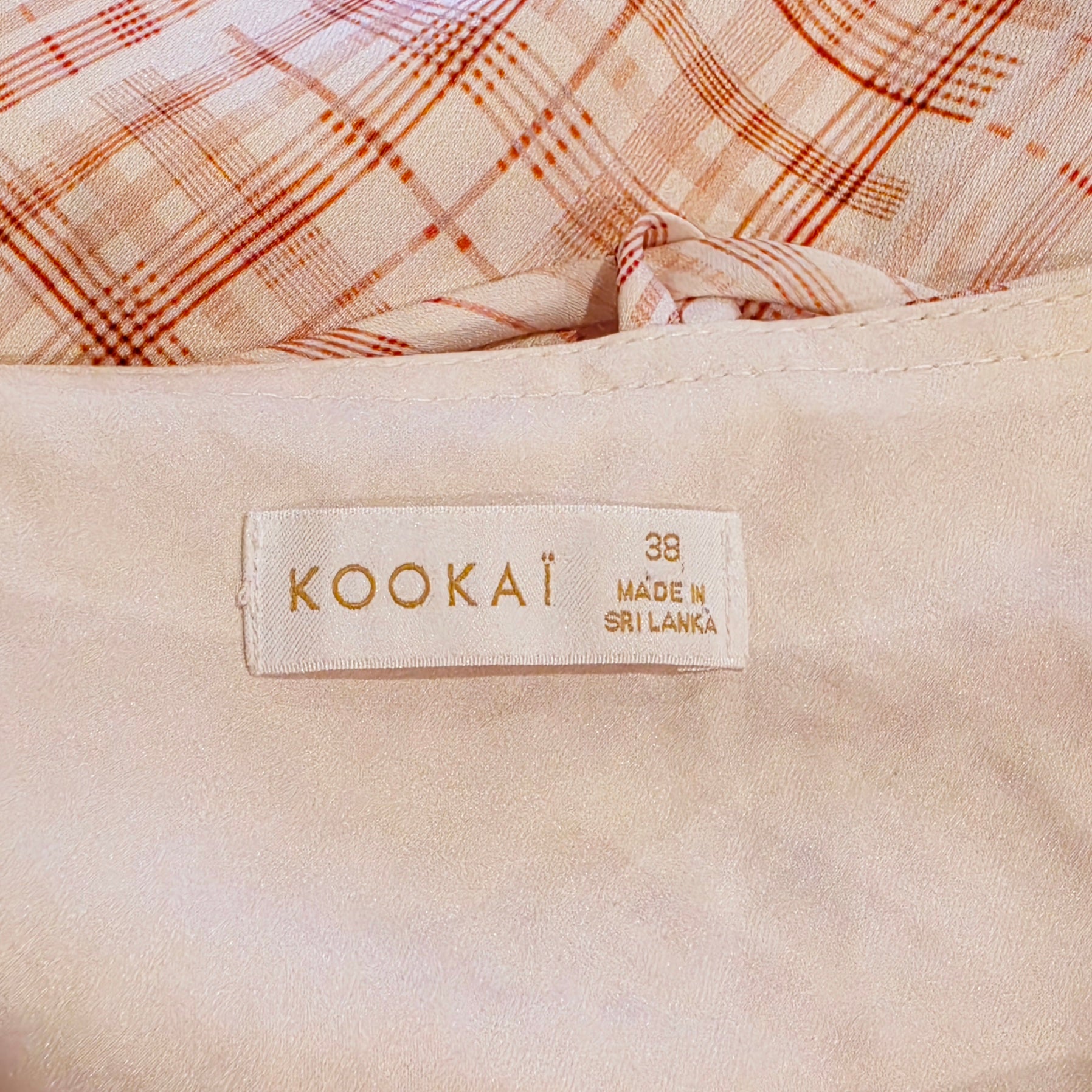 Close up view of the Kookai label showing size 38 on the checkmate slip midi dress