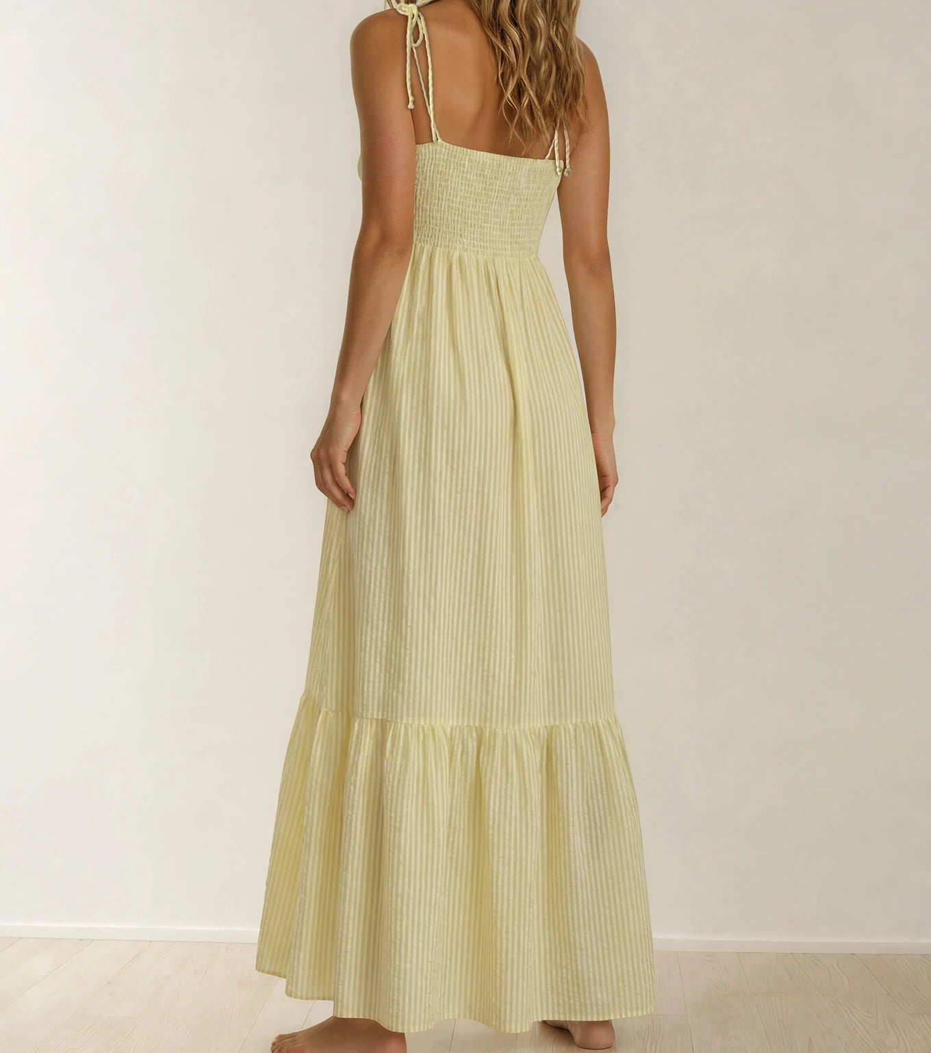Back view of the La Maison Talulah Layla Dress showing the tiered hemline, yellow stripes and tie spaghetti straps.