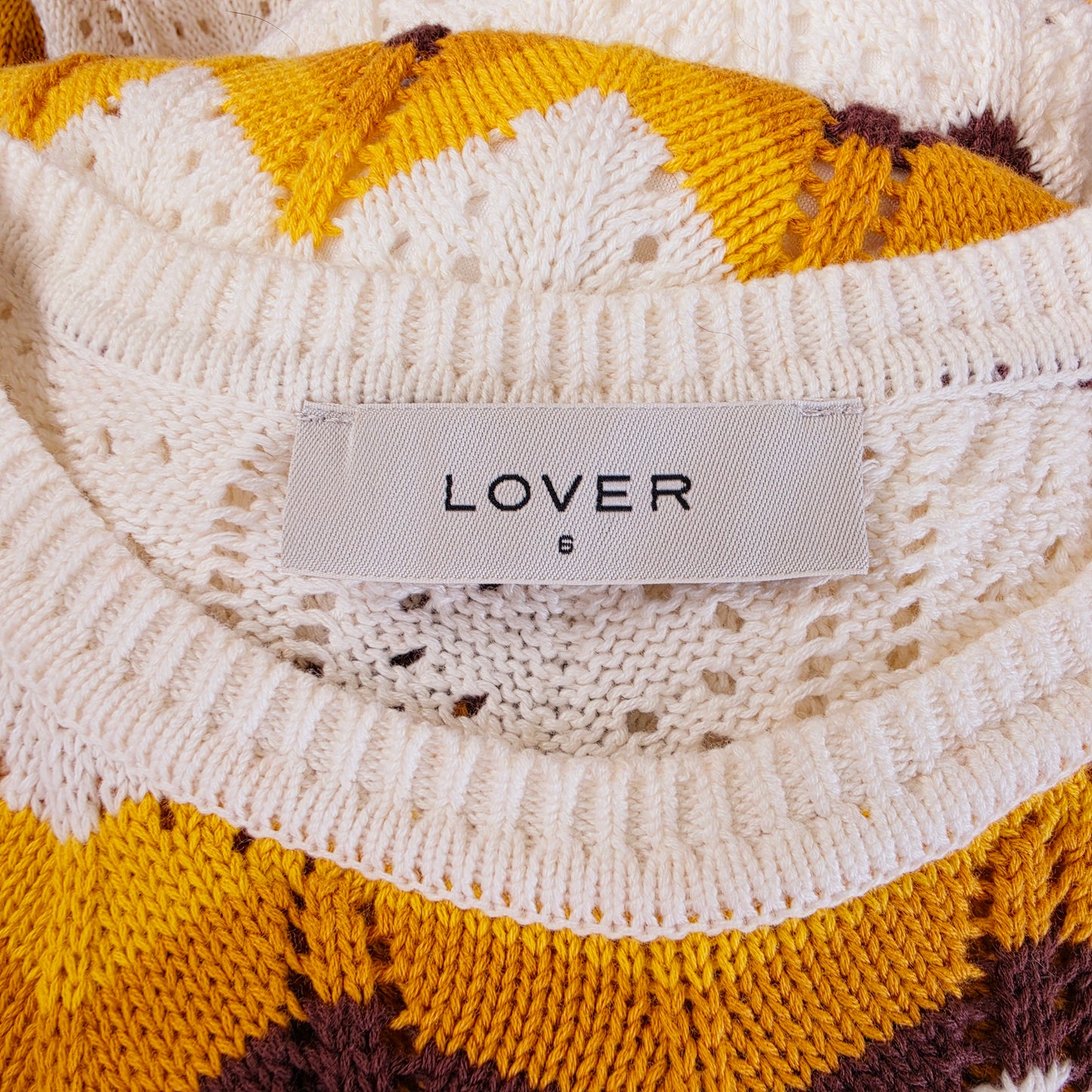Close up view of the label on the Lover Astrid Midi Dress in a size 6