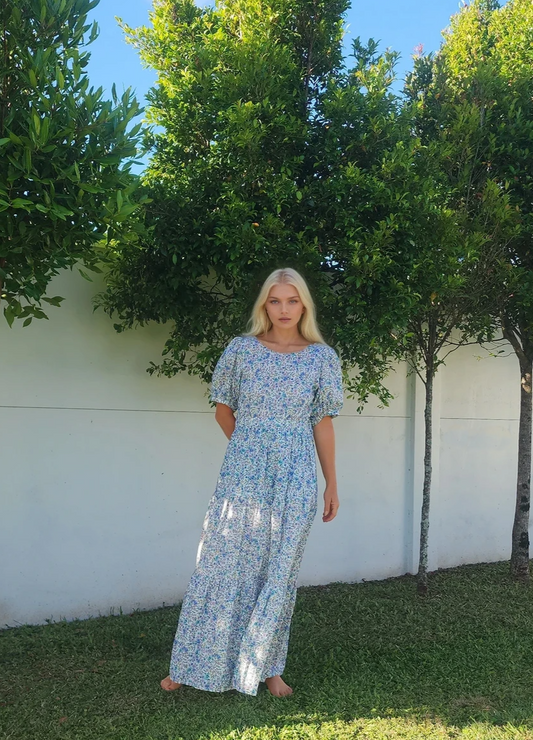 Model wearing Oak Meadow, showing the maxi dress style, maxi dress in blue floral. 