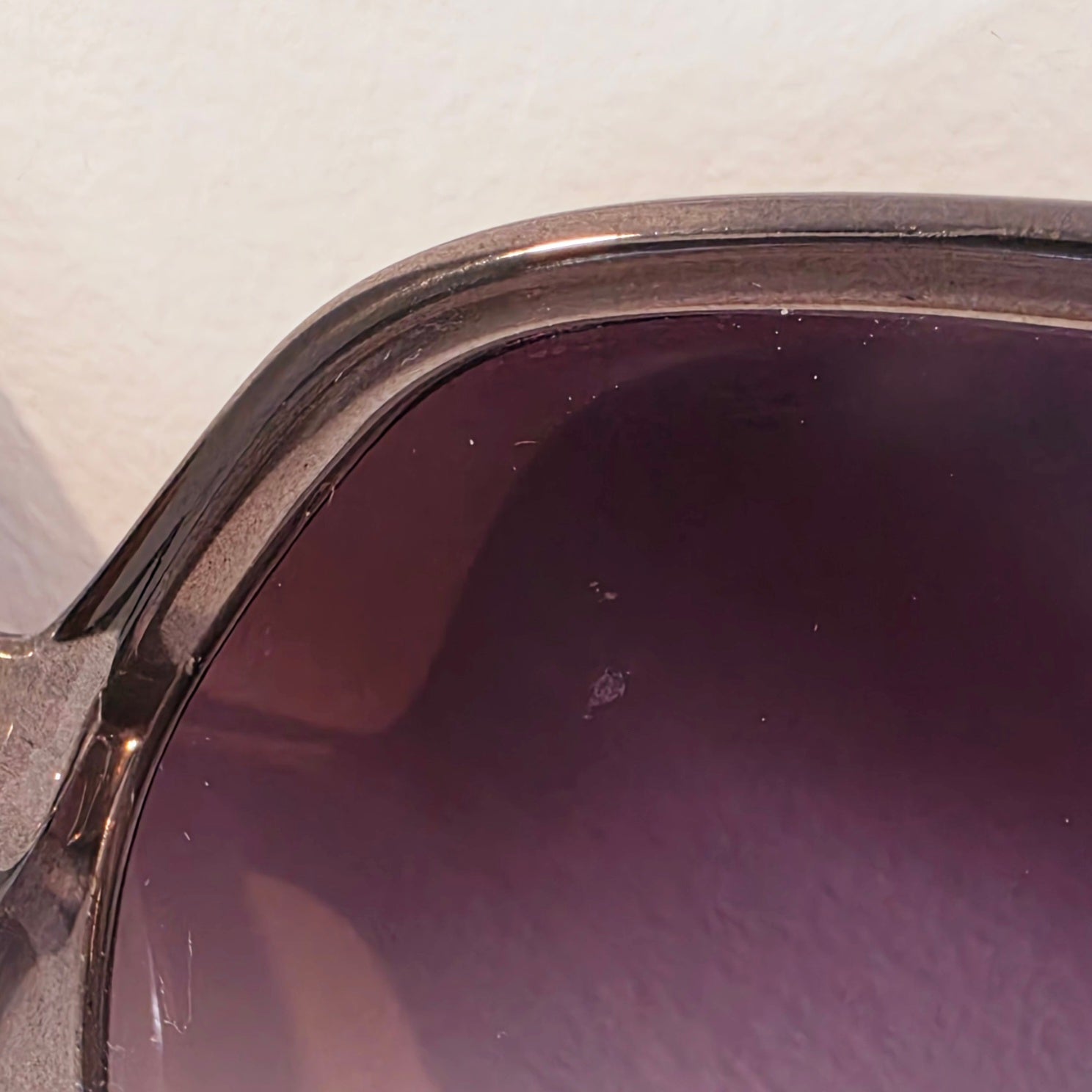 Close-up view of the lens on the oversized, round Chloe sungleassed, showing the graze to the inside of the lens.