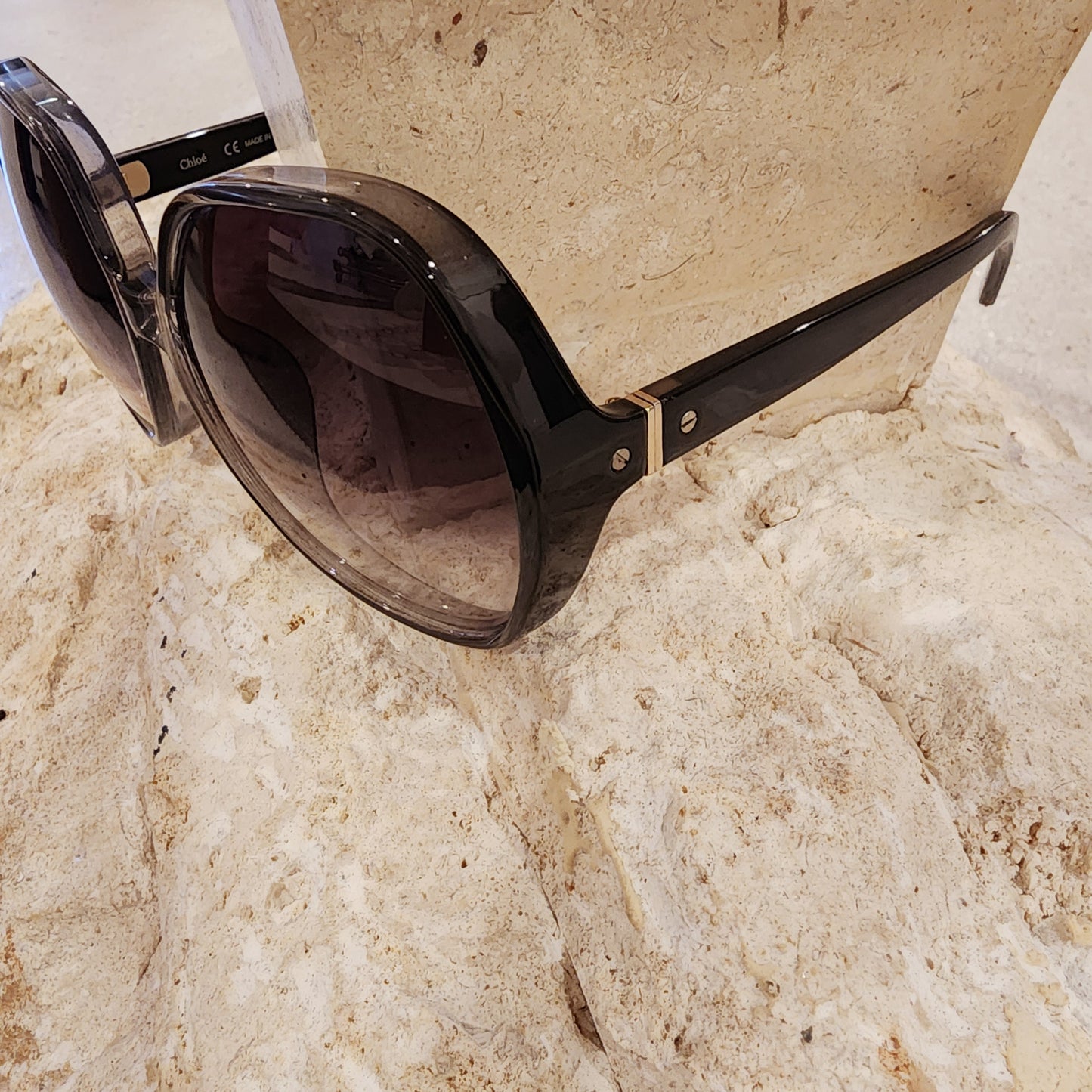 Side view of the oversized Chloe smokey grey sunglasses with a gradient lens. This image shows the temple detail and brand on the opposite temple.