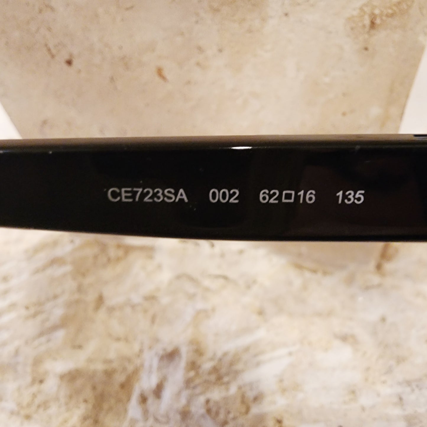 Close up view of the style number on the smokey grey, gradient, round, oversized sunglasses by Chloe.
