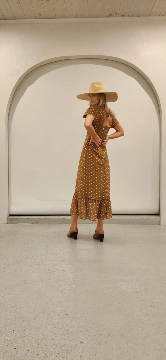Side view of the Ownley Vera midi dress showing the flattering silhouette and subtle ruffle hem.