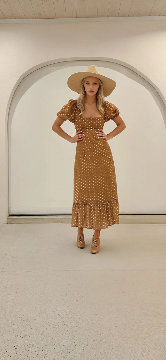 Front view of the Ownley Vera dress in golden brown with cream polka dots, featuring puff sleeves and a square neckline