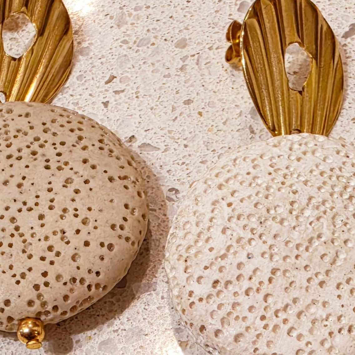 Close up view of the Lumen earrings showing the difference in colour between the cafe and crema colours