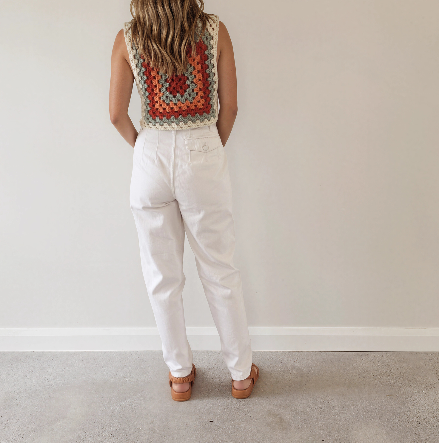 Women wearing the white Sass & Bide Jean, showing the back view with the button pocket detail and ankle length.