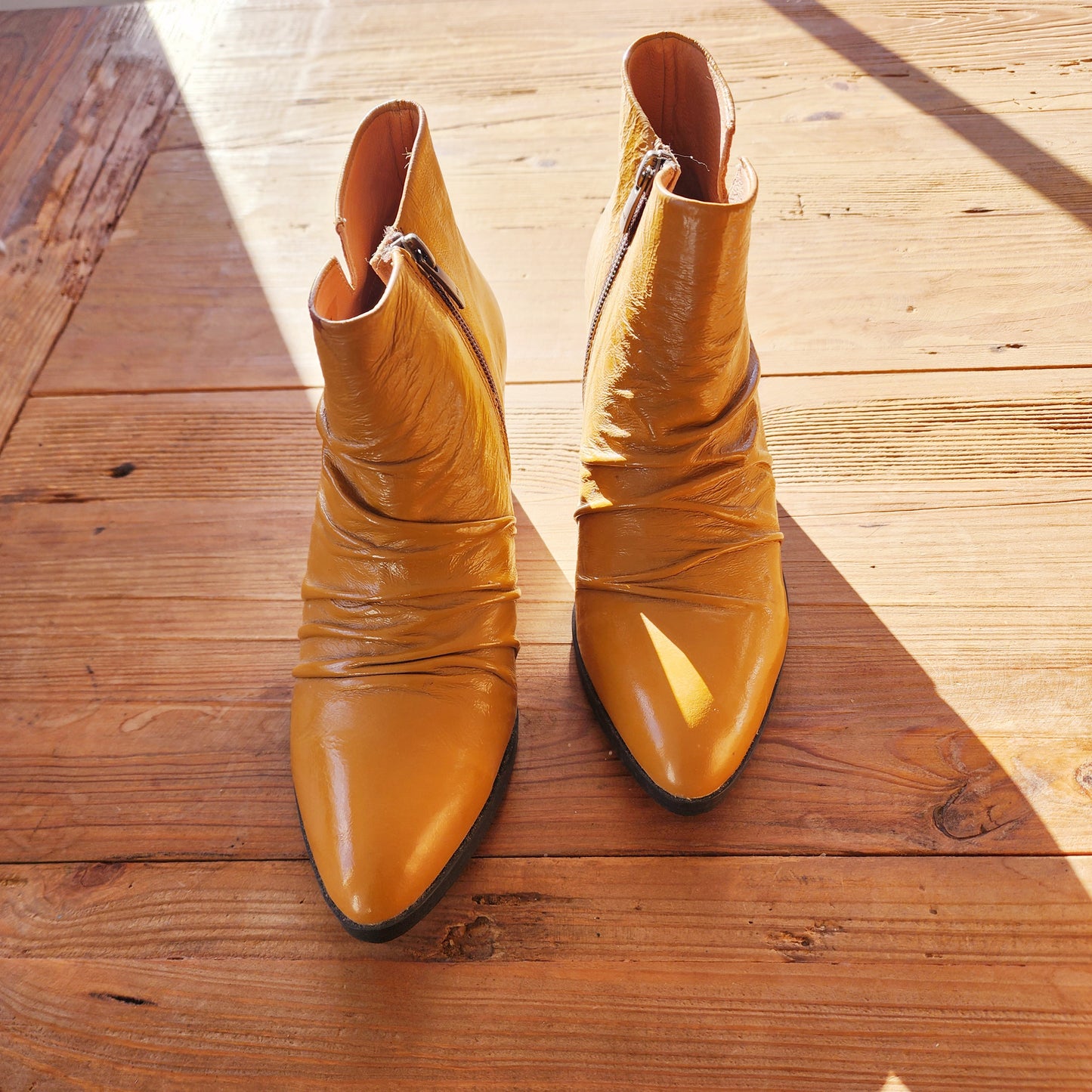 Front view of the Sempre Di creased mustard ankle boots in size 38, showing the intentional design creasing and mustard leather.