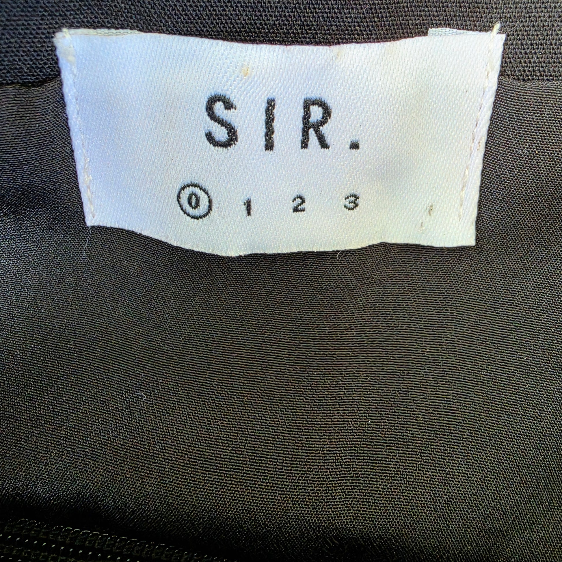Close up view of the inside brand tag for the SIR Andre Midi Dress