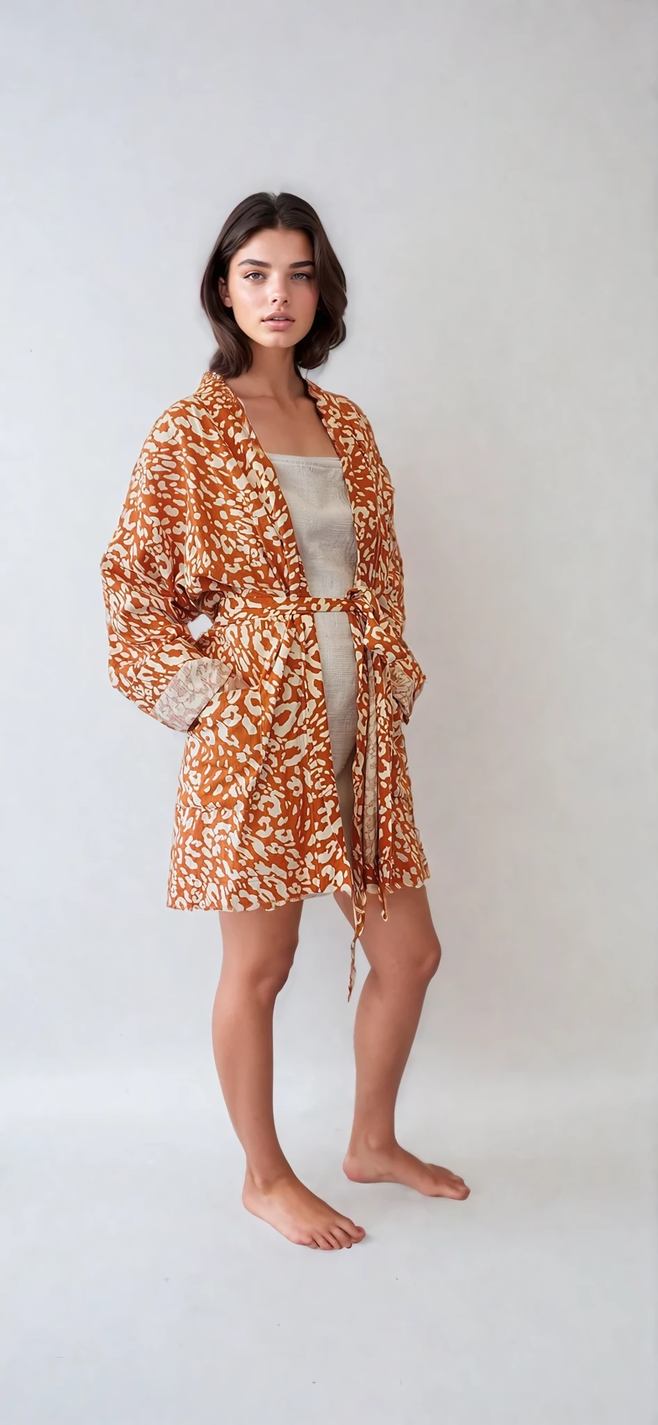 Model wearing The Travelling Kimono mid length gown in leopard print, showing the relaxed style.