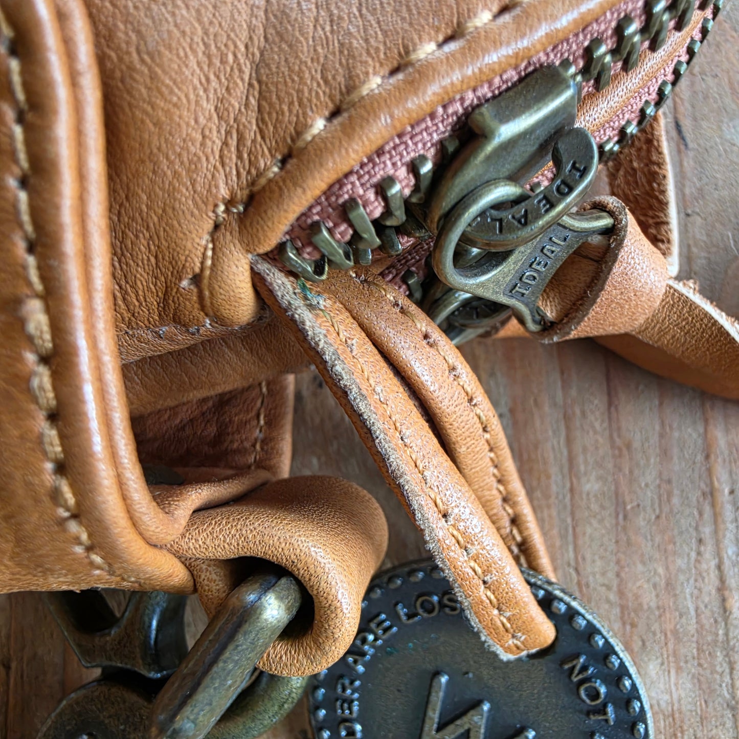 Close-up of natural wear and markings on tan leather Wanderers wallet