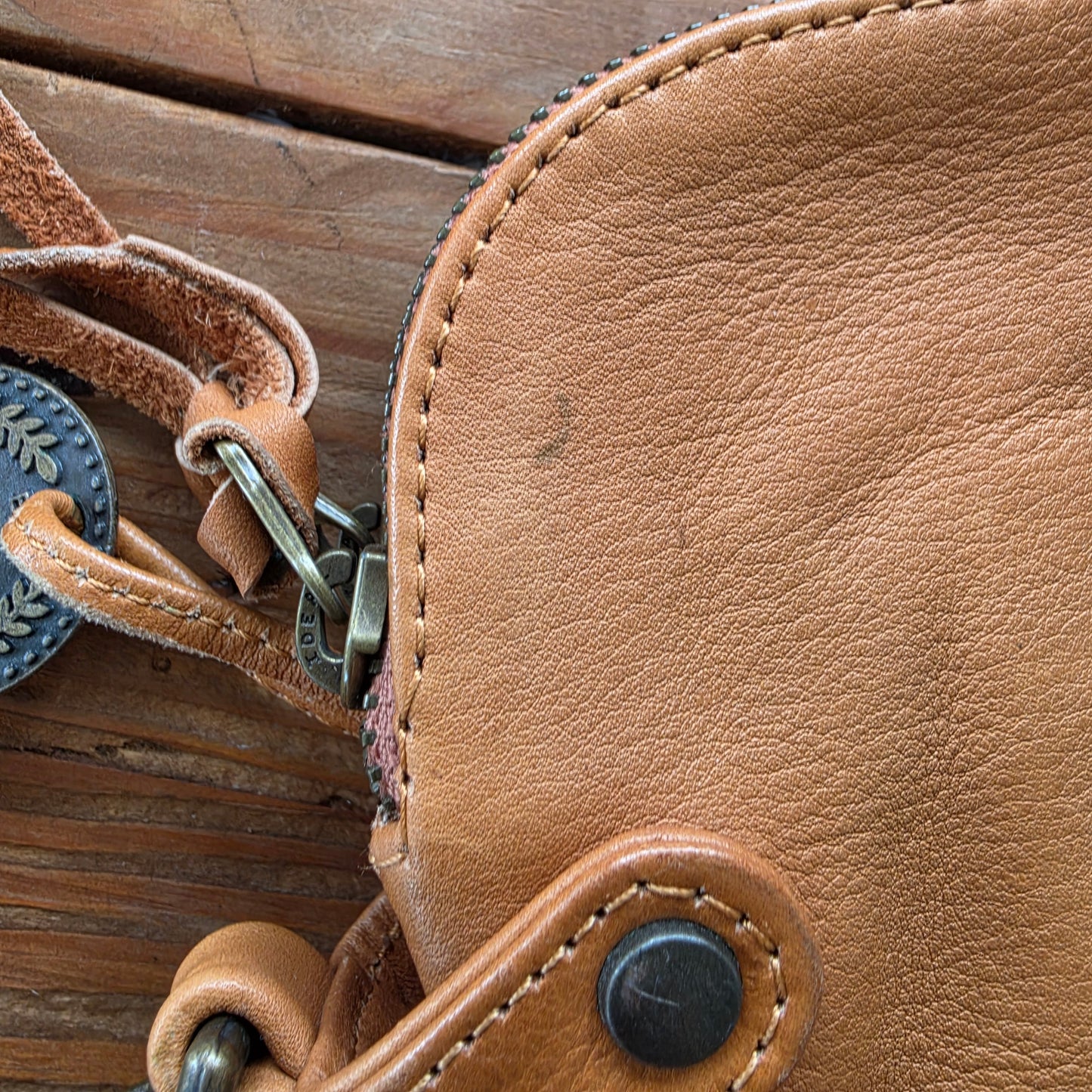 Close-up of wear and markings on tan leather Wanderers wallet