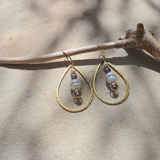 Top view of the Versamel earrings, showing the different coloured pearls, diamantes, brass and gold plated components