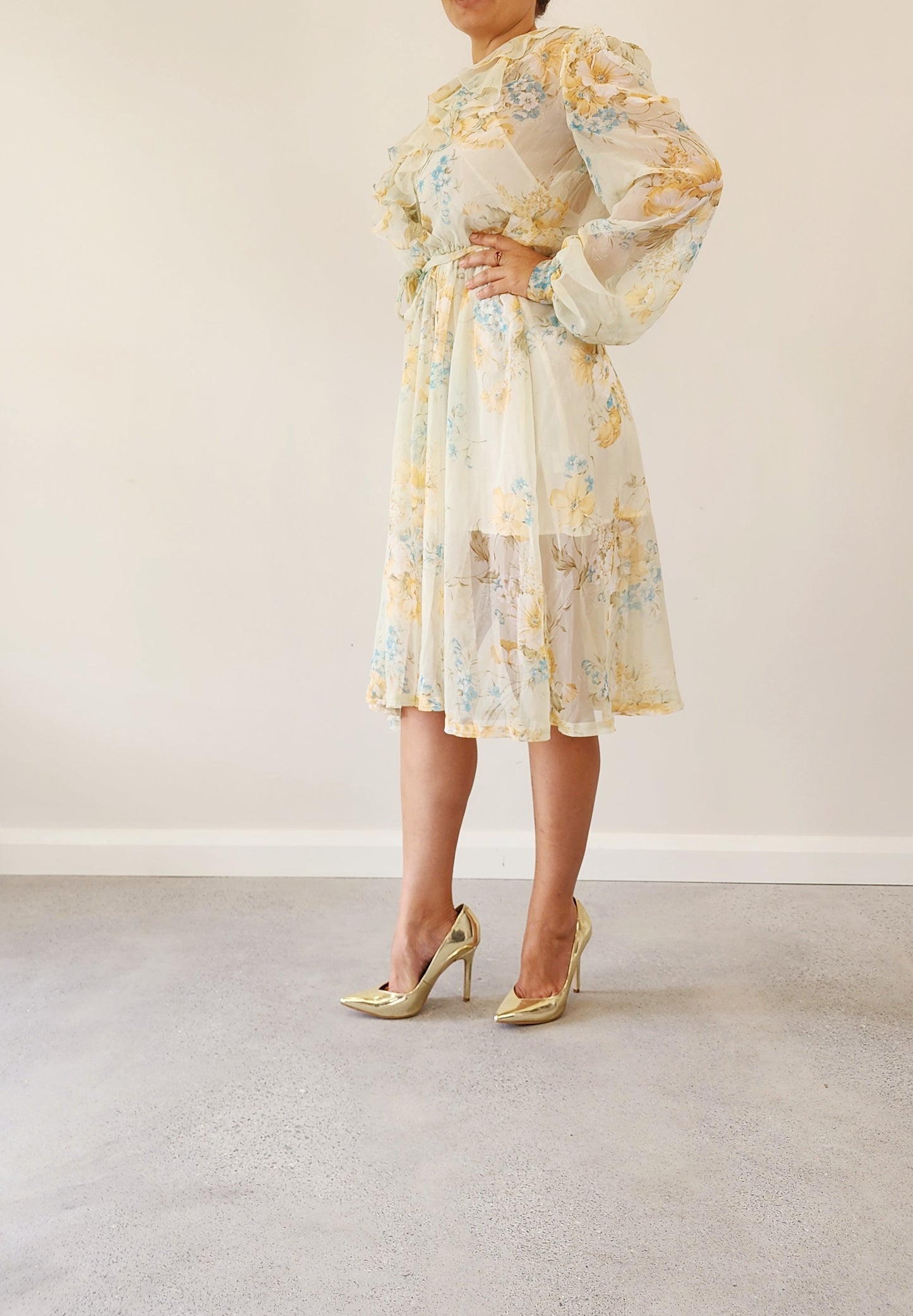 Side view of the vintage 70s sheer floral dress, showing the frill neckline and soft sleeves.