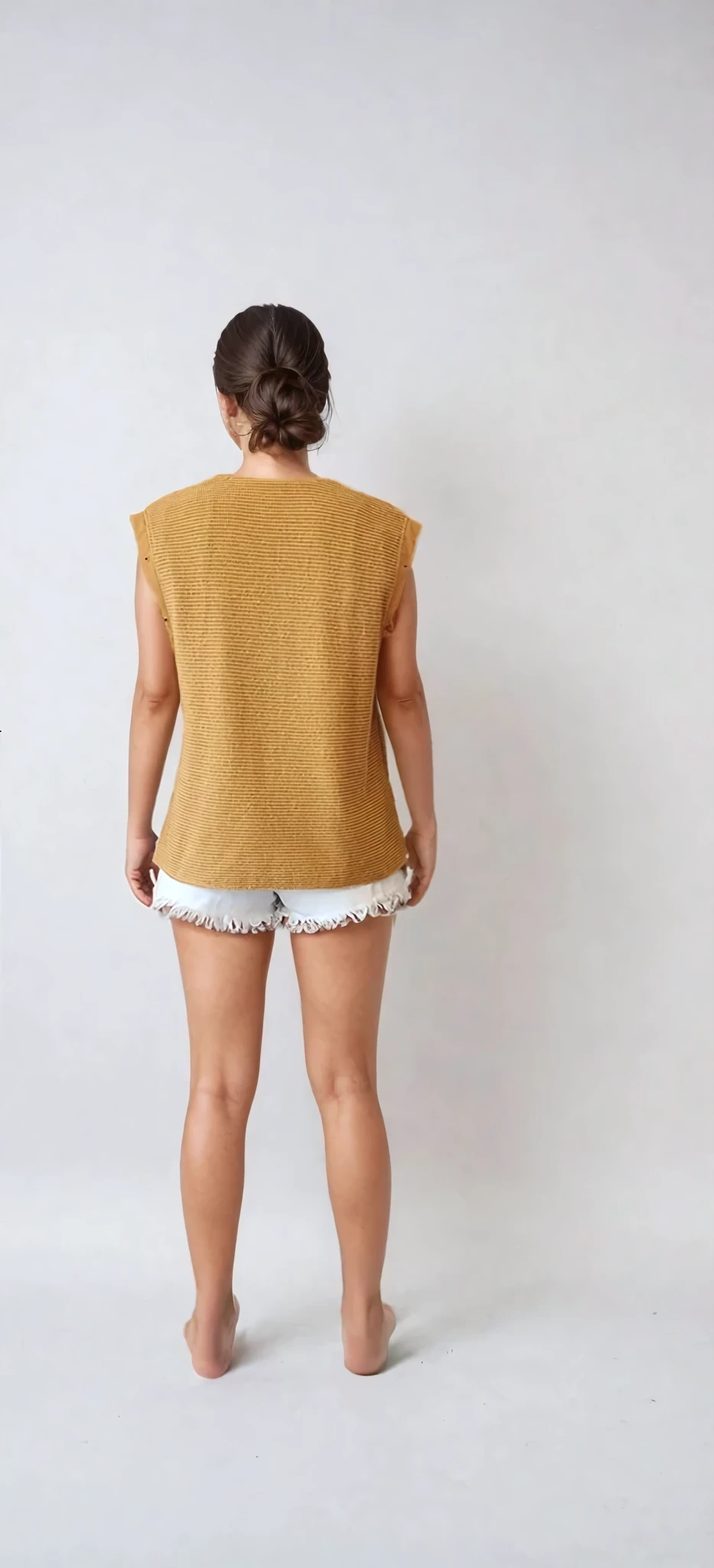 Back view of vintage Ara Modell mustard vest showing the woven style fabric.