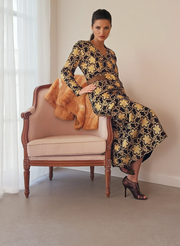 Stunning black with bold gold patterned dress. Vintage 70s with a longer sleeve and V-neck. The print has flowers and circles in gold. Available online at wilsonavenue.au