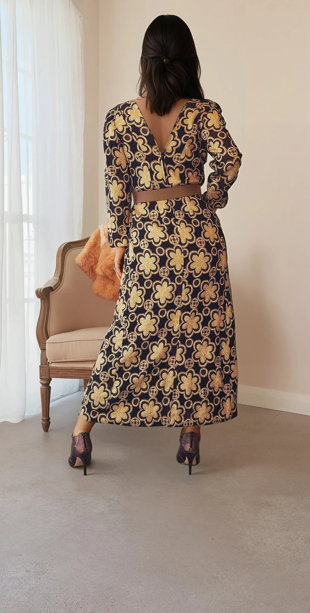 Stunning black with bold gold patterned dress. Vintage 70s with a longer sleeve and V-neck. The print has flowers and circles in gold. Available online at wilsonavenue.au