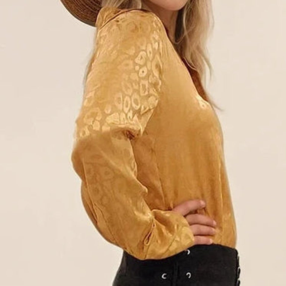 Close-up view of the side off the ACOA button up shirt, showing the retro shiny leopard print detail.