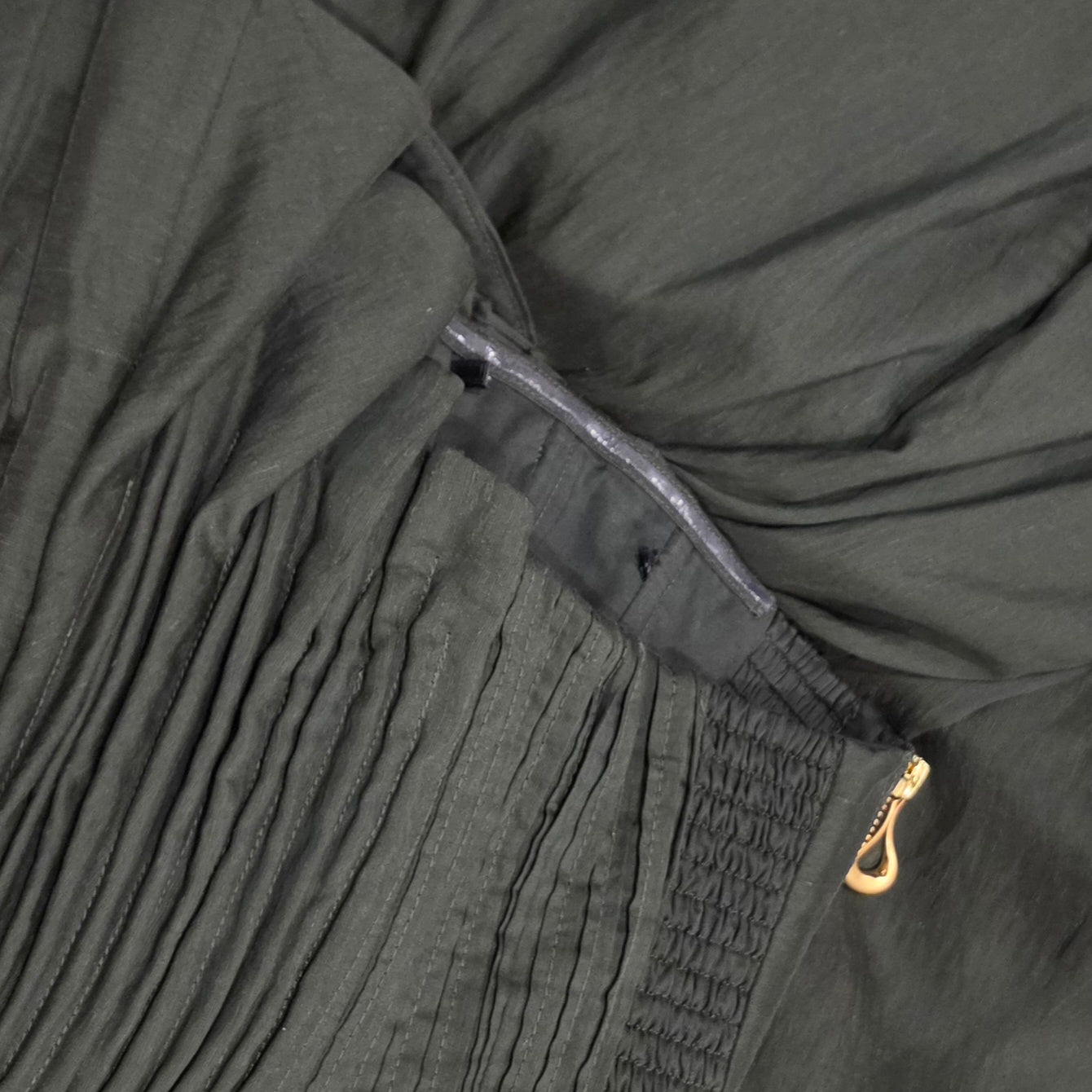 Close up of the coat hanger ties that have been removed from the inside of the Aje Aquiline Gown