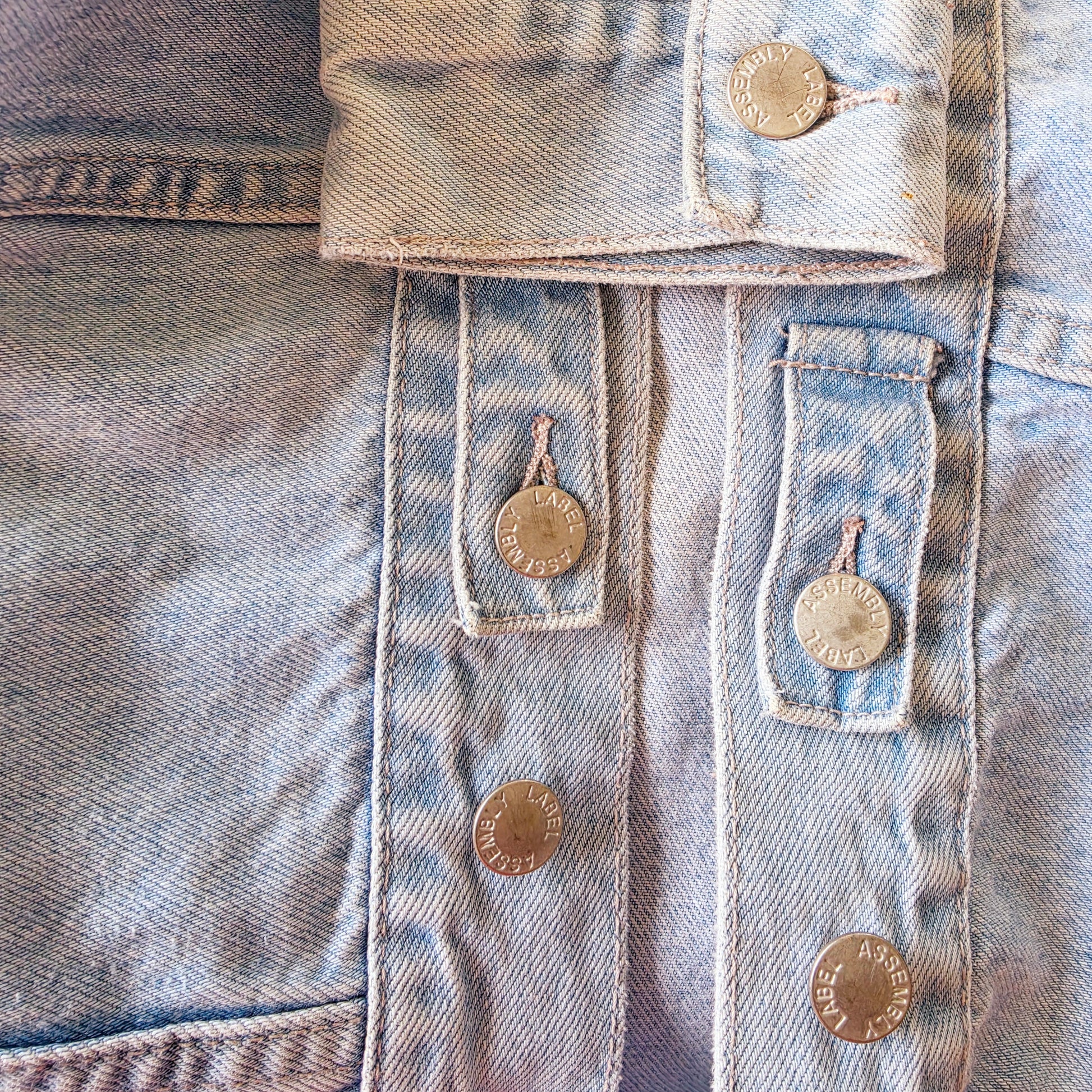 Close up view of the Assembly Label denim jacket showing the slight wear to the buttons.