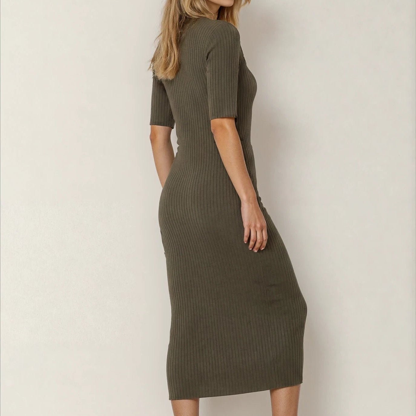 Back view of the Assembly Label olive green dress, showing the ribbed knit midi style.