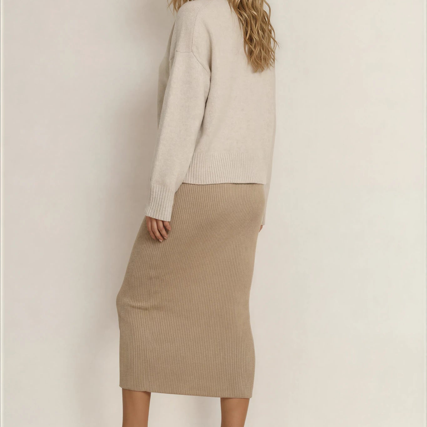Model showing the back view of the BAE ribbed midi skirt.