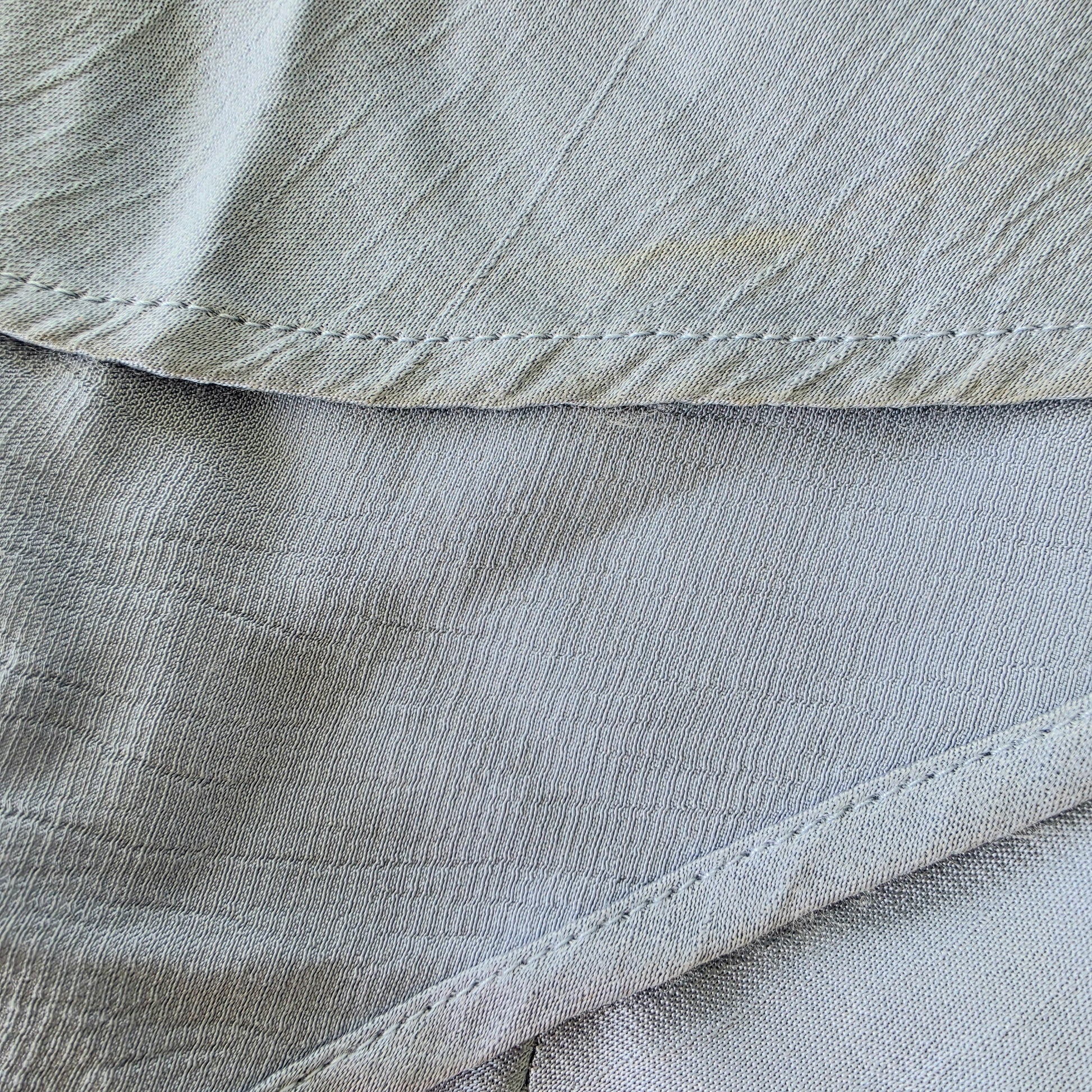 Close-up of the hemline on the Bec & Bridge Moon Dance Maxi Dress showing the discolouration of the fabric.