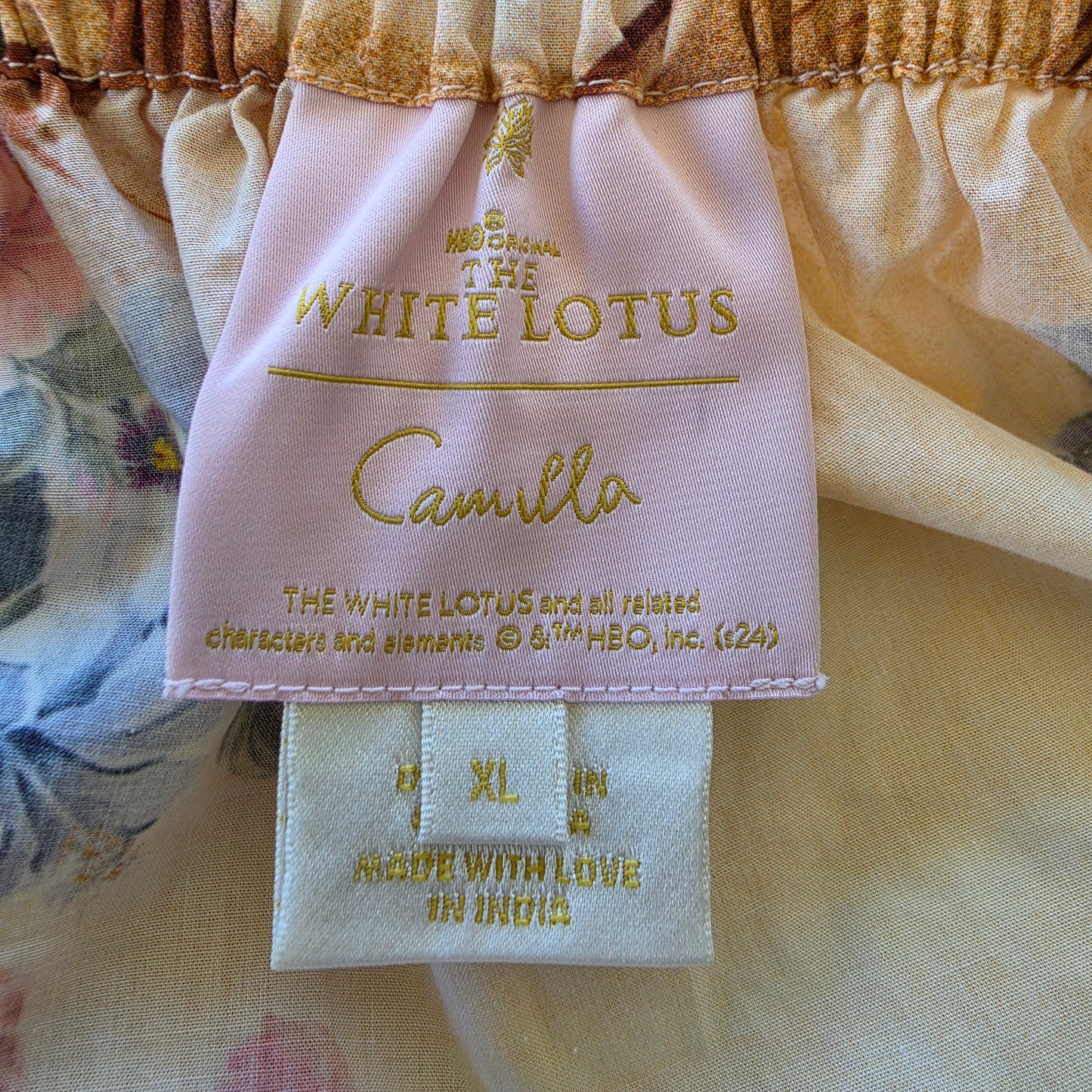 Close up view of the tag inside the CAMILLA x The White Lotus long dress, showing the size XL
