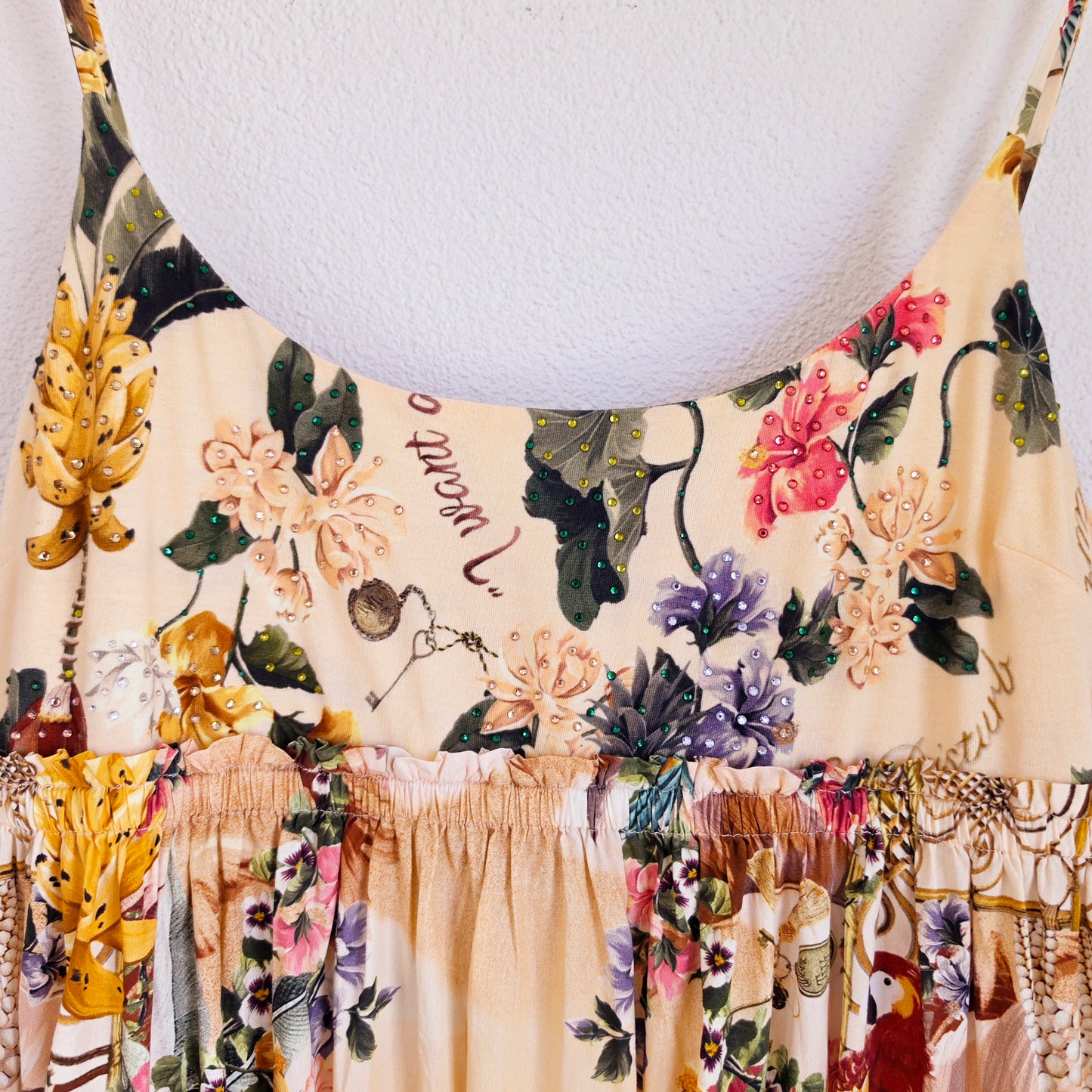 Close up view of the CAMILLA x The White Lotus long dress showing the jersey bodice, crystal embellished neckline and elastic underbust
