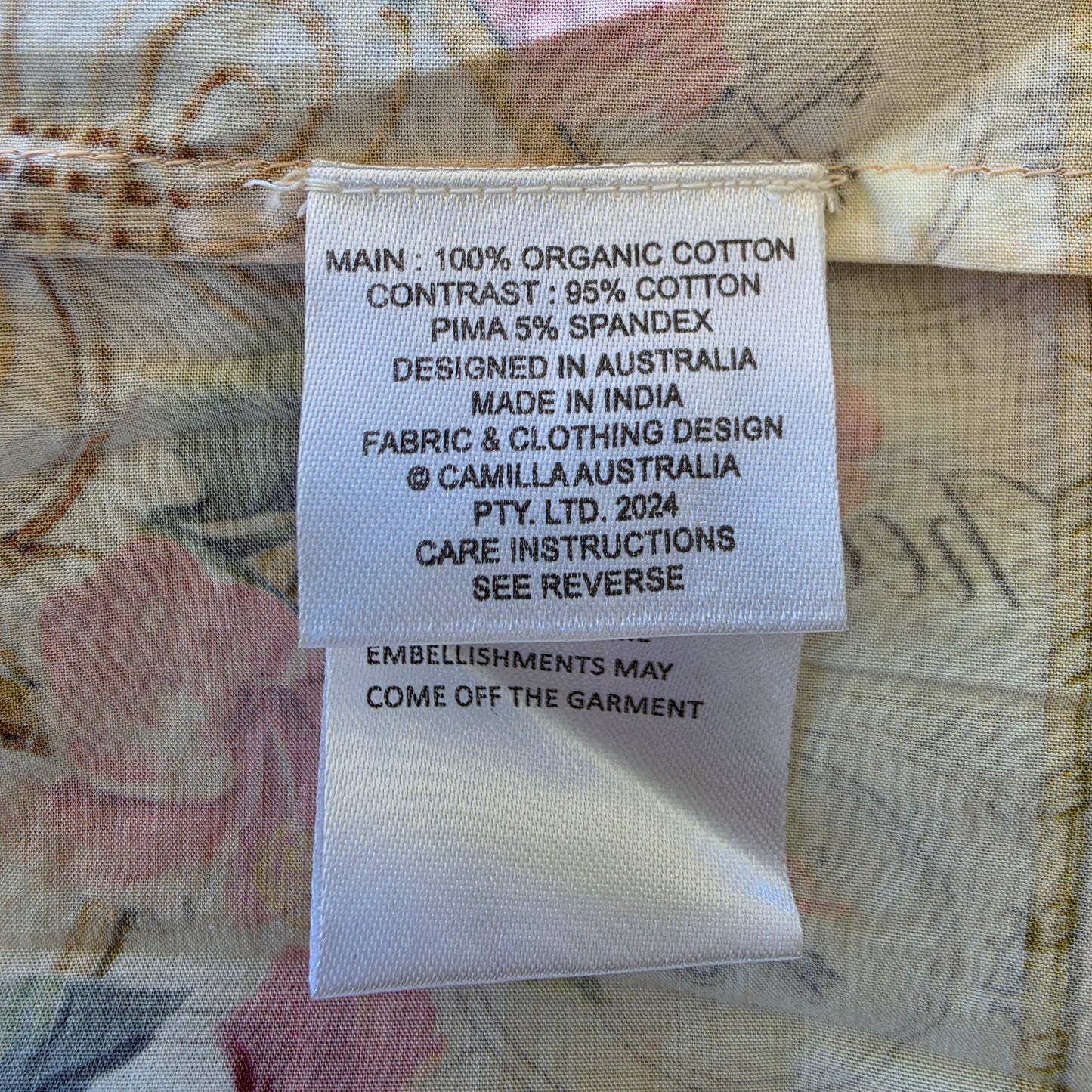 Close up view of the fabric label insode the CAMILLA x The White Lotus long dress