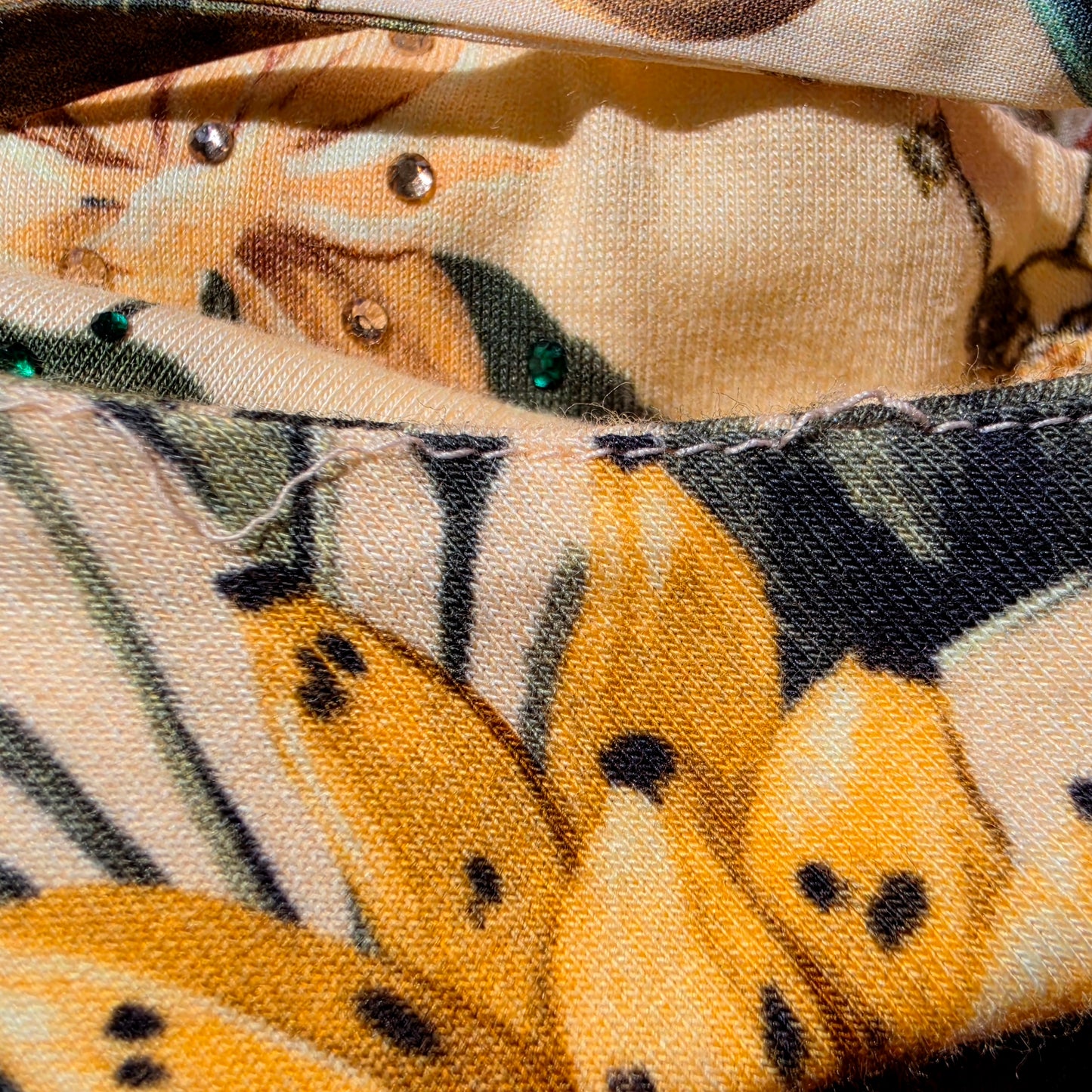 Close up of the thread pull on the Camilla X White Lotus long dress.