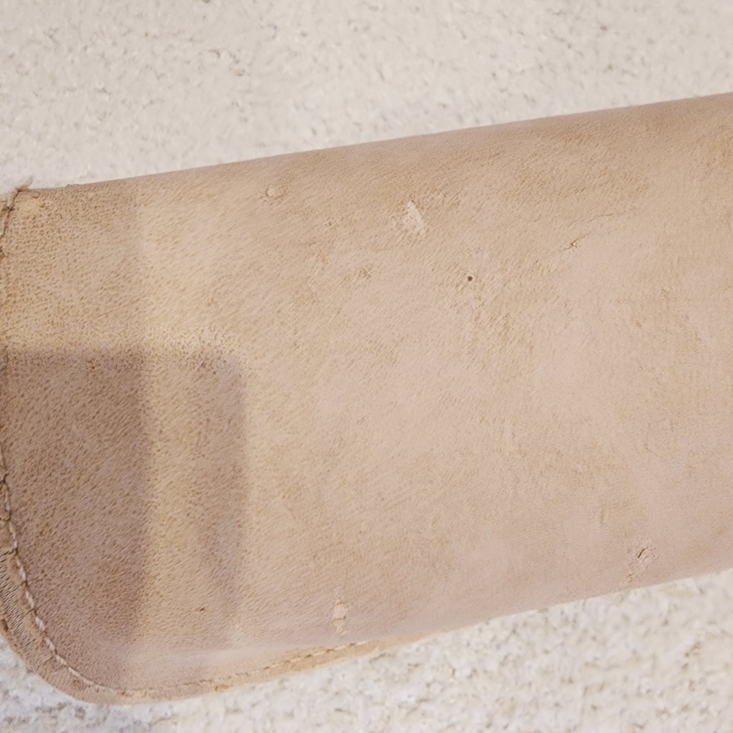 Back view of the chloe sunglasses case showing the peeling fabric