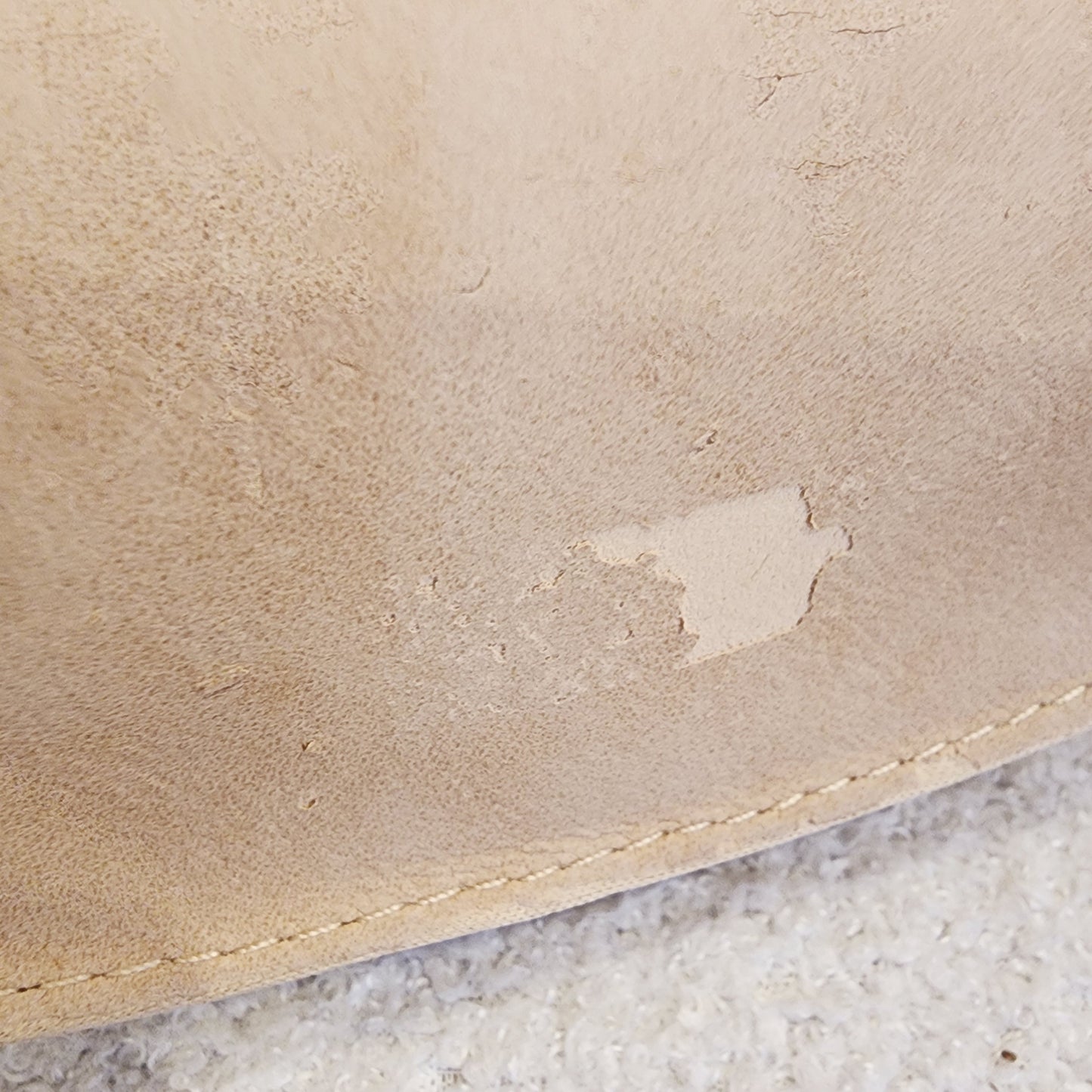 Close up view of the bottom of the Chloe sunglasses case showing the peeling fabric