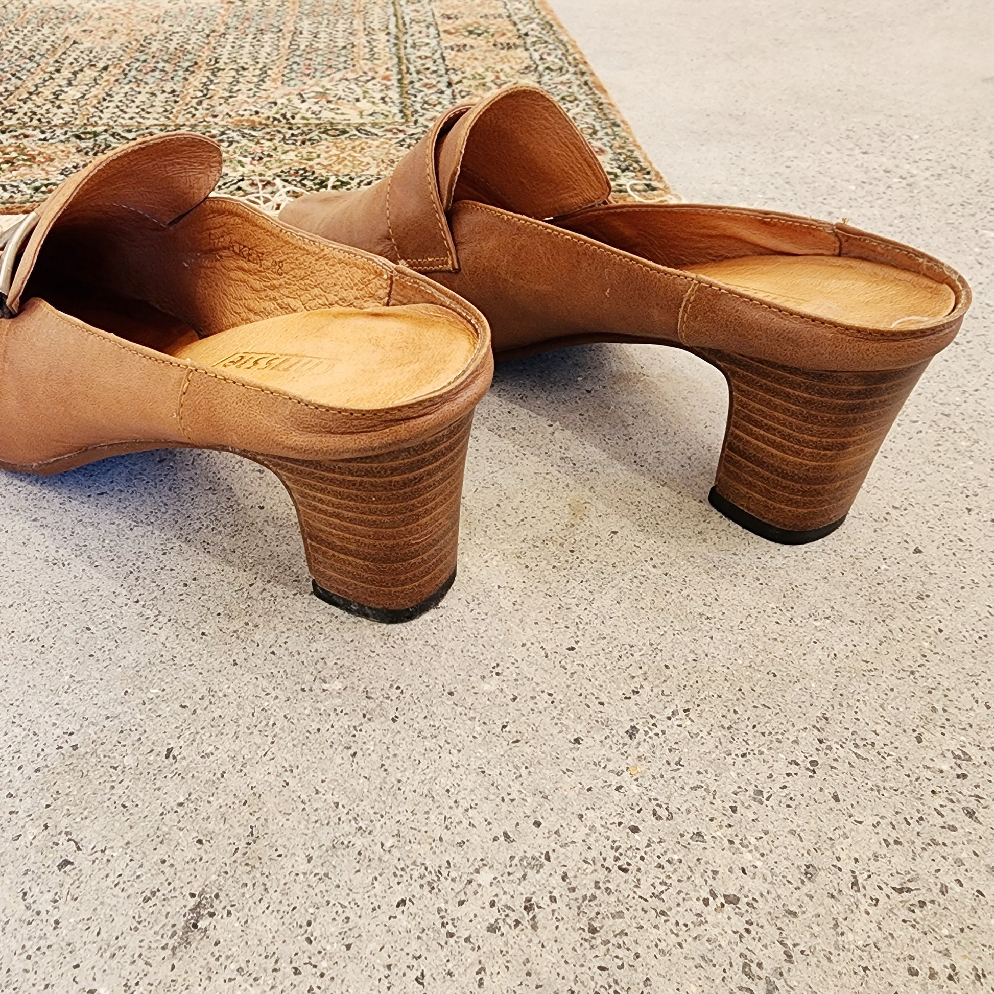 Rear angle of the Chrissie tan leather mules highlighting the heel height and leather texture.